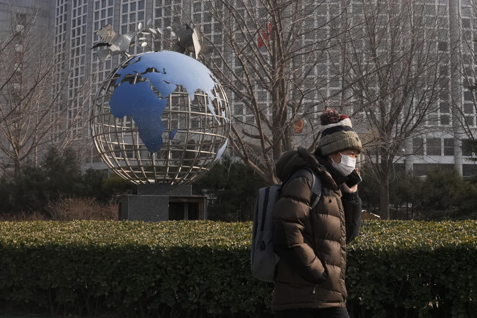 A woman walks by a globe sculpture displayed outside the Ministry of Foreign Affairs office in Beijing, Monday, Feb. 6, 2023. China on Monday accused the United States of indiscriminate use of force when the American military shot down a suspected Chinese spy balloon Saturday, saying that had "seriously impacted and damaged both sides' efforts and progress in stabilizing Sino-U.S. relations." (AP Photo/Andy Wong)