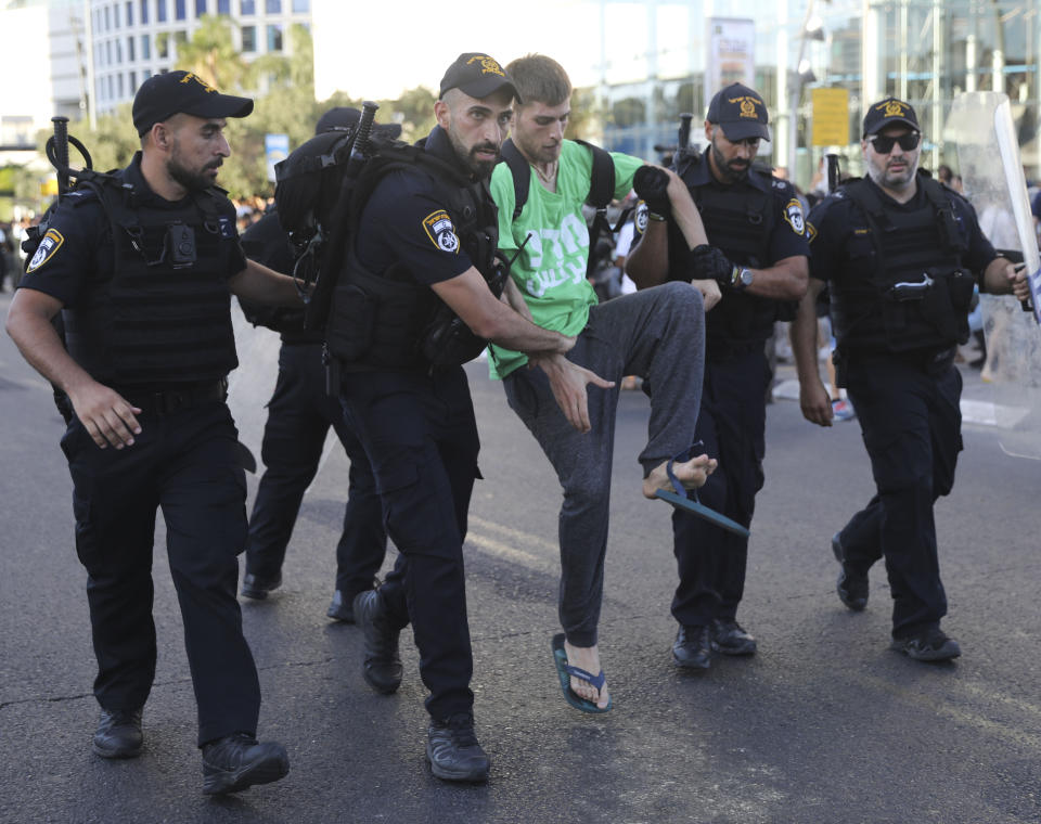 Police arrest a a man during a protest in Tel Aviv, Israel, Wednesday, July 3, 2019. Israeli police were bracing for another day of violent protests Wednesday after community activists called for renewed street demonstrations in response to the killing of an Ethiopian-Israeli teen by an off-duty police officer. (AP Photo/Oded Balilty)