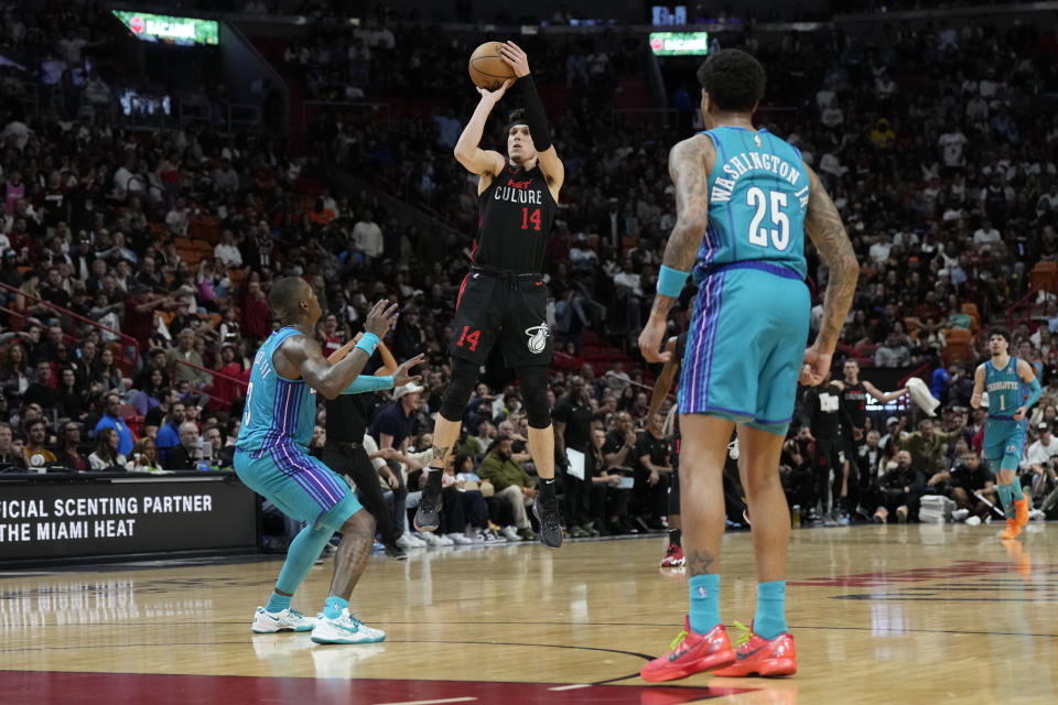 Miami Heat guard Tyler Herro (14) attempts a 3-pointer during the first half of an NBA basketball game against the Charlotte Hornets, Sunday, Jan. 14, 2024, in Miami. (AP Photo/Lynne Sladky)