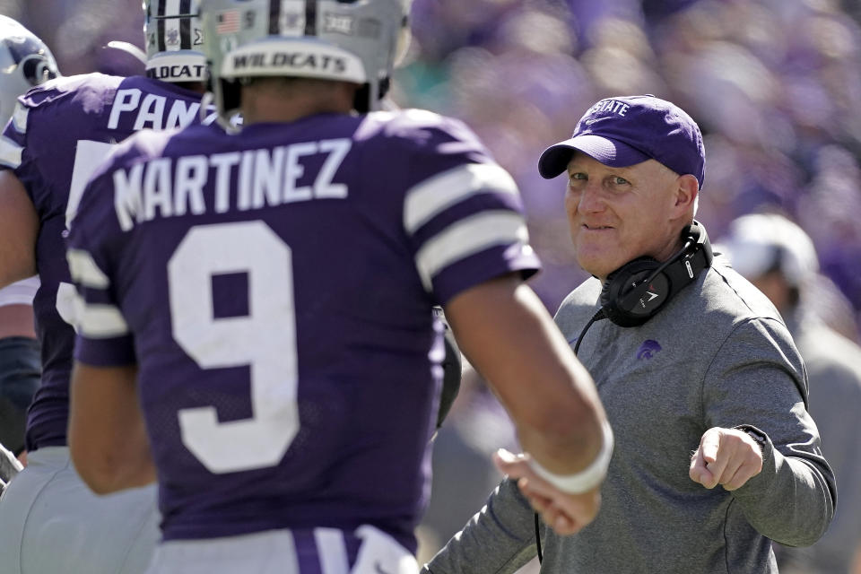 Kansas State head coach Chris Klieman greets quarterback Adrian Martinez (9) after Martinez ran for a touchdown during the second half of an NCAA college football game against Texas Tech Saturday, Oct. 1, 2022, in Manhattan, Kan. Kansas State won 37-28. (AP Photo/Charlie Riedel)