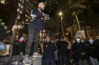 Ray O'Shannasy, top, speaks out during a protest he helped organize in Sydney, Tuesday, June 2, 2020, to support the cause of U.S. protests over the death of George Floyd and urged their own government to address racism and police violence. Floyd died last week after he was pinned to the pavement by a white police officer who put his knee on the handcuffed black man's neck until he stopped breathing. (AP Photo/Rick Rycroft)