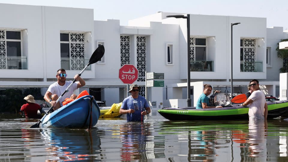 Residents move their belongings on a kayak at a flooded residential complex following heavy rainfall, in Dubai, United Arab Emirates on Thursday. - Amr Alfiky/Reuters