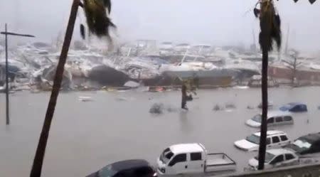 General view of half-submerged vehicles, boats and debris in the flooded harbour as Hurricane Irma hits the French island territory of Saint Martin September 6, 2017, in this video grab made from footage taken from social media. Mandatory credit RCI GUADELOUPE/Handout via REUTERS