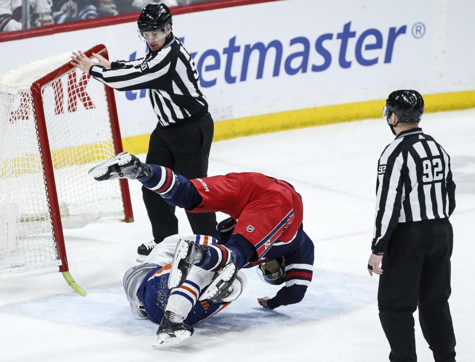 Winnipeg Jets' Brenden Dillon, right, and Edmonton Oilers' Darnell Nurse fight during the second period of an NHL hockey game Tuesday, March 26, 2024, in Winnipeg, Manitoba. (John Woods/The Canadian Press via AP)