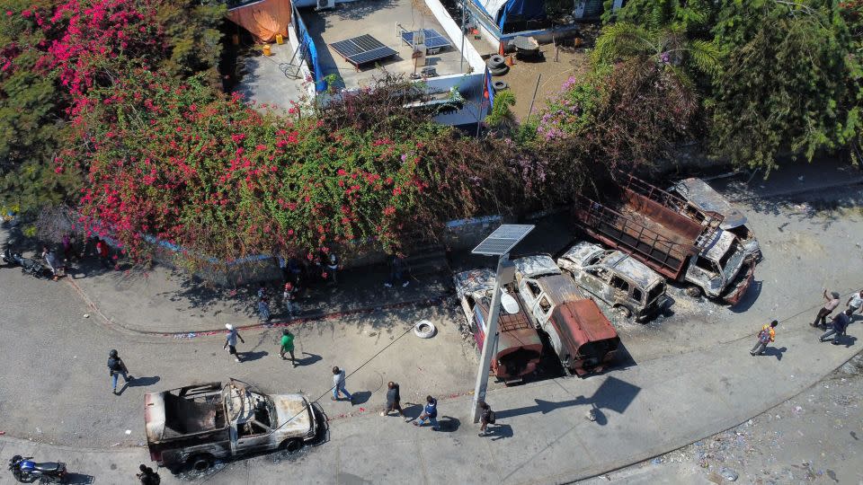 Burnt-out vehicles are shown in front of the police station at Carrefour de l'Aeroport, in Port-au-Prince, Haiti, March 5, 2024 after it was torched by armed individuals controlled by gang leader Jimmy "Barbecue." - Clarens Siffroy/AFP/Getty Images