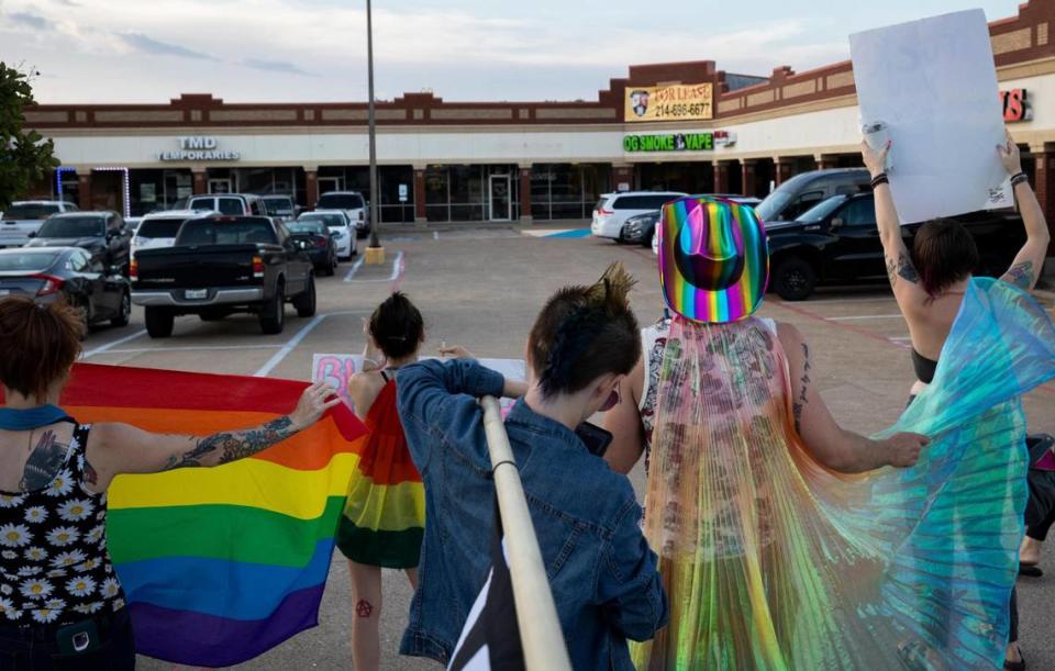 Protesters hold signs as church members leave a service at Stedfast Baptist Church on June 1. The No Hate In Texas group is asking the city and property owners to evict the church again. The group protests twice a week to coincide with the services.