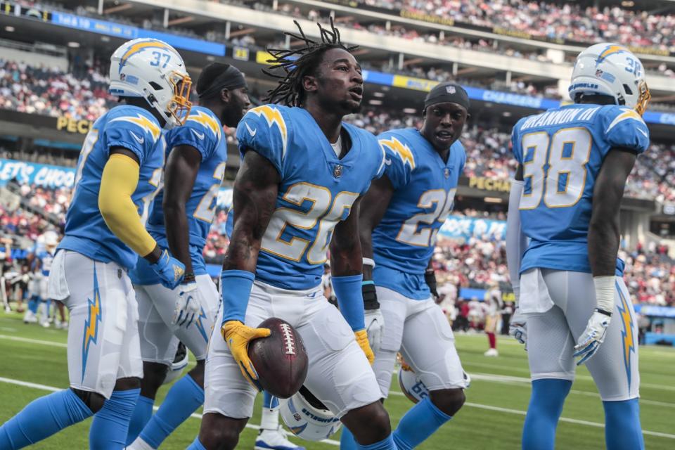 Chargers cornerback Asante Samuel Jr. celebrates with teammates after a first quarter interception.