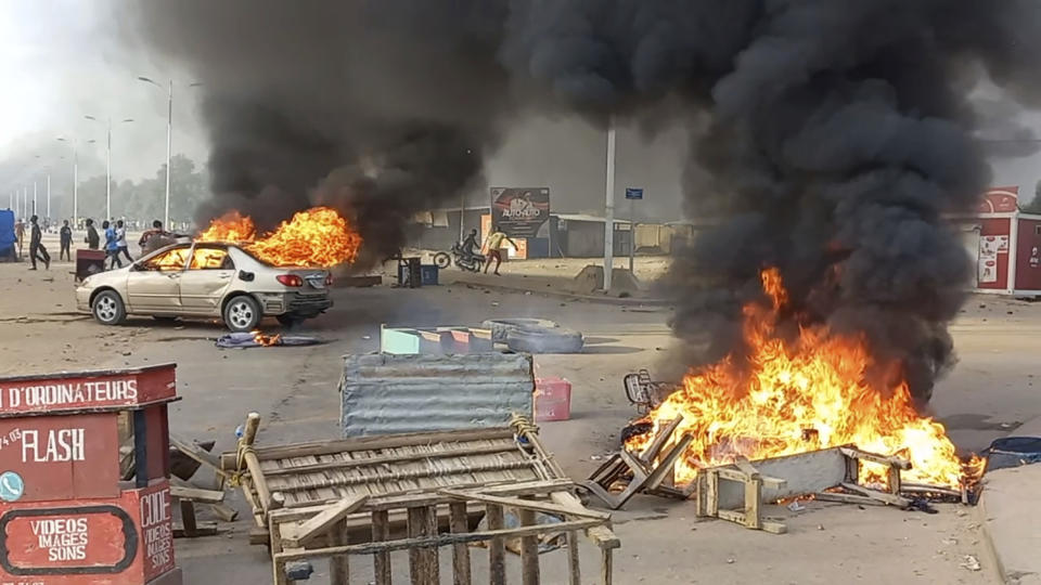 Anti-government demonstrators set a barricade on fire during clashes in N'Djamena, Chad, Thursday Oct. 20, 2022. Chadian security forces have opened fire on anti-government demonstrators in the country's two largest cities killing at least 60 people, the government spokesman and a morgue official said. Authorities imposed a curfew after Thursday's violence, which came amid protests in the central African nation against interim leader Mahamat Idriss Deby's two-year extension of power. (AP Photo)