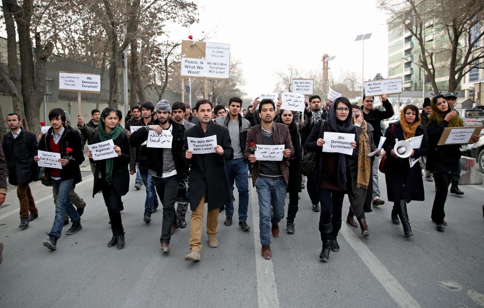 Afghan members of civil society organizations chant slogans as they march in a street, during an anti terrorism demonstration in Kabul, Afghanistan, Sunday, Jan. 19, 2014. Hundreds of Afghans gathered outside a Lebanese restaurant in Kabul on Sunday to protest against Taliban attack that killed 21 people. The assault Friday by a Taliban bomber and two gunmen against the La Taverna du Liban restaurant was deadliest single attack against foreign civilians in the course of a nearly 13-year U.S.-led war there now approaching its end. They chanted slogans against terrorism as they laid flowers at the site of the attack. The dead included 13 foreigners and eight Afghans, all civilians. The attack came as security has been deteriorating and apprehension has been growing among Afghans over their country's future as U.S.-led foreign forces prepare for a final withdrawal at the end of the year. (AP Photo/Massoud Hossaini)