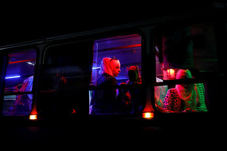 People travel in a bus after arriving to recently opened international fair in Damascus, Syria, September 12, 2018. REUTERS/Marko Djurica/Files