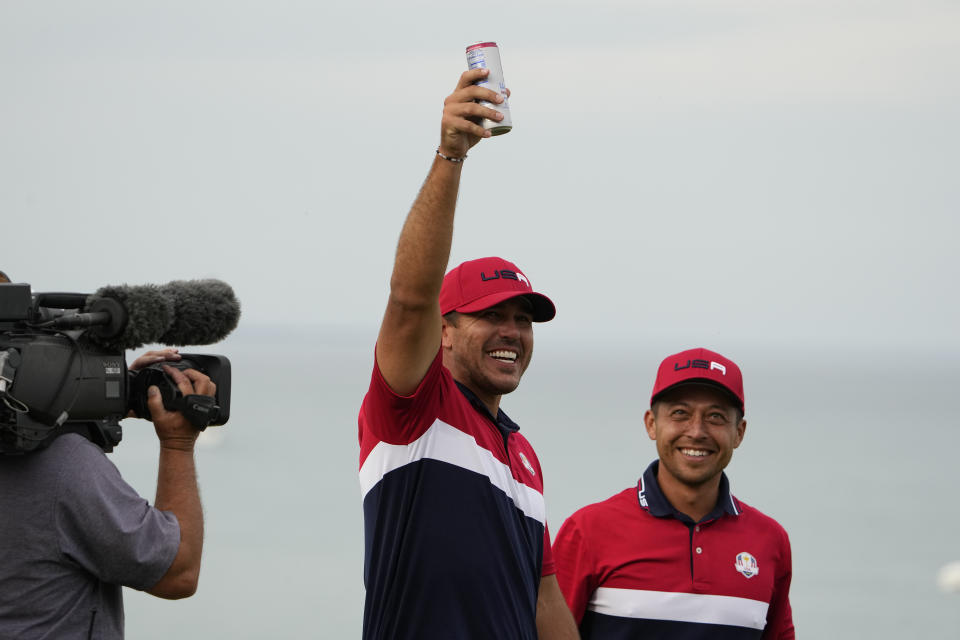 FILE - Team USA's Brooks Koepka holds up his drink after winning during a Ryder Cup singles match at the Whistling Straits Golf Course Sunday, Sept. 26, 2021, in Sheboygan, Wis. Koepka is the only player with LIV Golf picked for the U.S. team that goes to Rome this year. (AP Photo/Jeff Roberson, File)