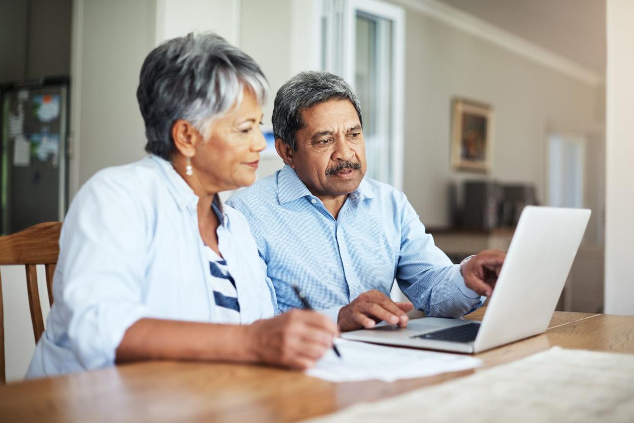 Cropped shot of a senior couple using a laptop to do their household budget