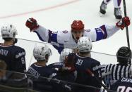 Russia's Pavel Buchnevich celebrates after scoring the winning goal in front of U.S. players in their IIHF Ice Hockey World Championship quarter-final match in Malmo January 2, 2014. REUTERS/Alexander Demianchuk (SWEDEN - Tags: SPORT ICE HOCKEY TPX IMAGES OF THE DAY)