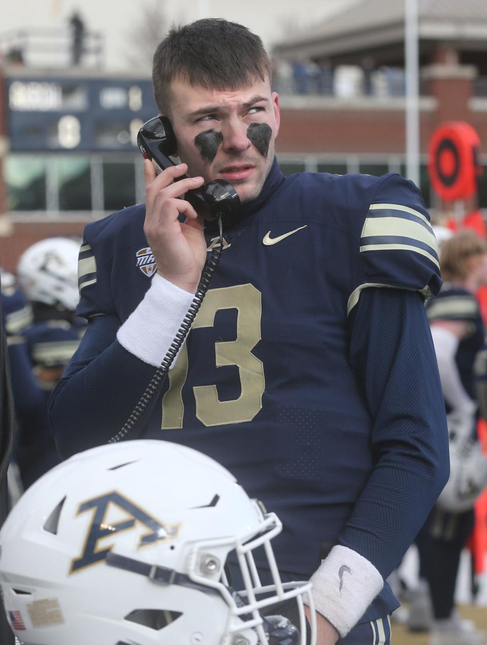 University of Akron quarterback Jeff Undercuffer, Jr. talks to coaches during the game against Ohio on Friday, Nov. 24, 2023.
