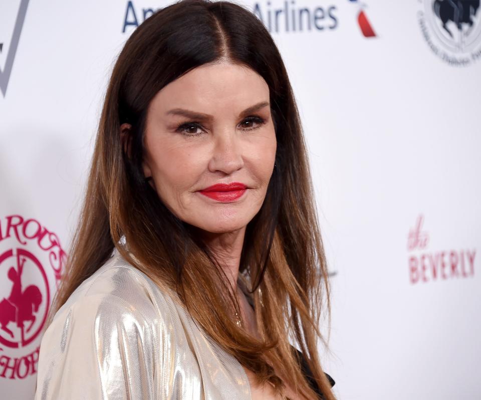 Janice Dickinson in a red lip and metallic top