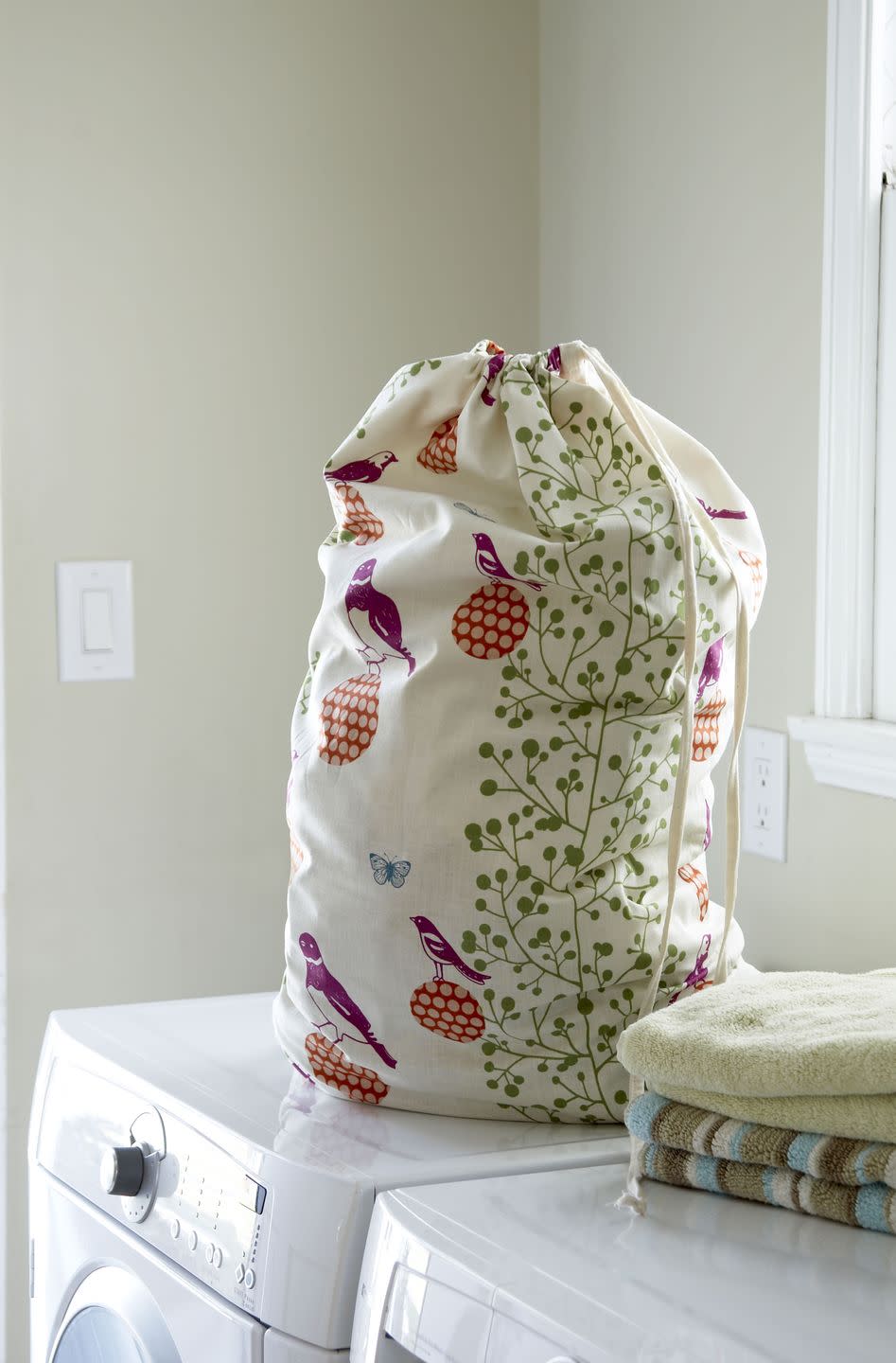 <p>Instead of a laundry bin in the bathroom, invest in a set of drawstring cotton laundry bags (buy from <a href="https://www.amazon.co.uk/s?k=drawstring+cotton+laundry+bag&ref=nb_sb_noss" rel="nofollow noopener" target="_blank" data-ylk="slk:Amazon" class="link ">Amazon</a>) to hang on the back of every bedroom door. This avoids dirty clothes piling up on the floor and is also more hygienic, as the bags can be washed too. </p>