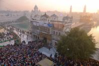 <p>Indian Sikh devotees pay respects on the first day of the year at the Golden Temple in Amritsar on January 1, 2016. </p>