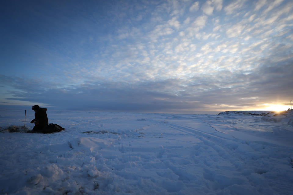 Mick Woods fishes for tomcod and smoalt on the Bering Sea Saturday, Jan. 18, 2020, in Toksook Bay, Alaska. The first Americans to be counted in the 2020 Census starting Tuesday, Jan. 21, live in this Bering Sea coastal village. The Census traditionally begins earlier in Alaska than the rest of the nation because frozen ground allows easier access for Census workers, and rural Alaska will scatter with the spring thaw to traditional hunting and fishing grounds. (AP Photo/Gregory Bull)