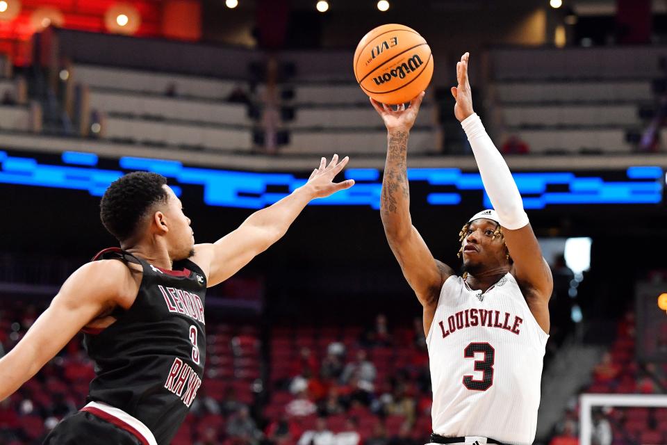 Louisville guard El Ellis (3) shoots over the defense of Lenoir-Rhyne guard L.J. McCoy (3) during action of their exhibition game, Sunday, Oct. 30 2022 in Louisville Ky.