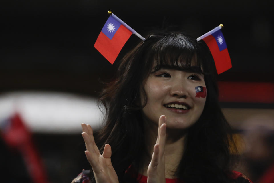 A girl wears a Taiwanese flags on her head while watching the Pool A game between Taiwan and Panama during the World Baseball Classic (WBC) held at Taichung Intercontinental Baseball Stadium in Taichung, Taiwan, Wednesday, March 8, 2023 (AP Photo/I-Hwa Cheng)