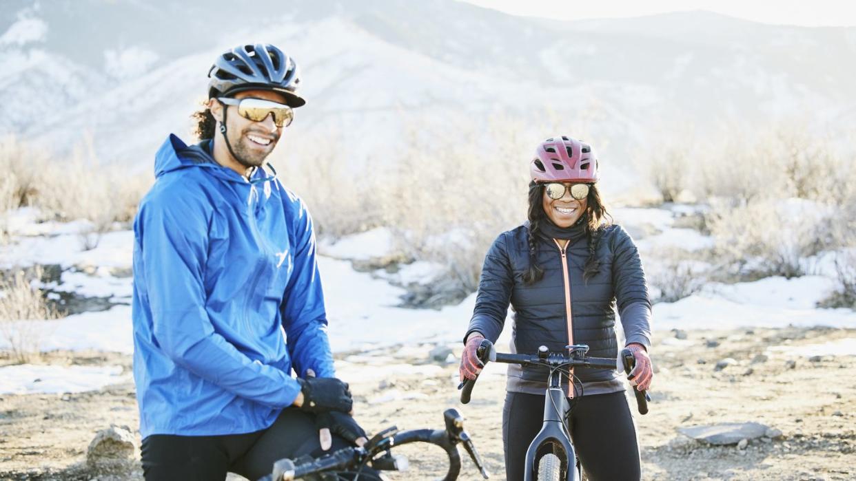 portrait of smiling friends on gravel bike ride on winter afternoon