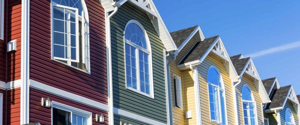 A row of colorful new townhouses or condominiums.