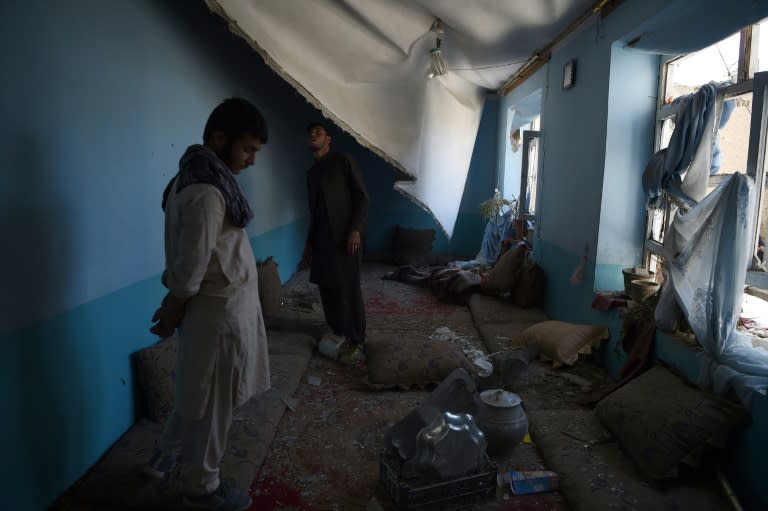 Afghan residents inspect inside a damage house following a hit by a NATO airstrike at a residential house in Kabul on September 28, 2017