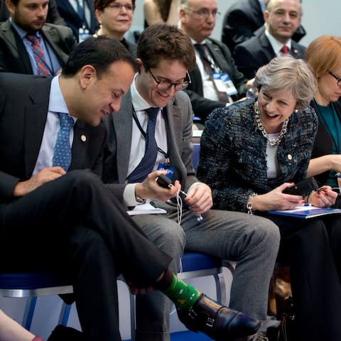 Irish Prime Minister Leo Varadkar, left, shows his decorative socks to British Prime Minister Theresa May, second right, during a round table meeting at an EU summit in Goteborg, Sweden on Friday, Nov. 17 - Credit: AP