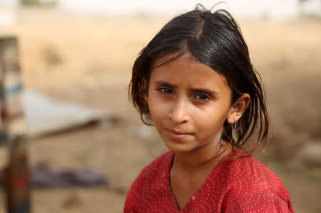 Amal Jabir, 10, looks on as she sits at the Shawqaba camp for internally displaced people who were forced to leave their villages by the war in Yemen's northwestern province of Hajja March 12, 2016. REUTERS/Abduljabbar Zeyad