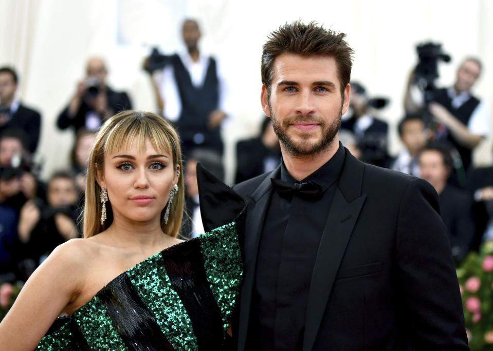 FILE - In this May 6, 2019 file photo, Miley Cyrus, left, and Liam Hemsworth attend The Metropolitan Museum of Art's Costume Institute benefit gala celebrating the opening of the "Camp: Notes on Fashion" exhibition in New York. Cyrus and Hemsworth have separated after less than a year of marriage. A representative for the singer said Saturday, Aug. 10 the pair decided a break was best while they focus on “themselves and careers.” Cyrus and Hemsworth, who starred in “The Hunger Games” films, have been an on-and-off again couple for more than a decade. They married in December 2018.  (Photo by Charles Sykes/Invision/AP, File)