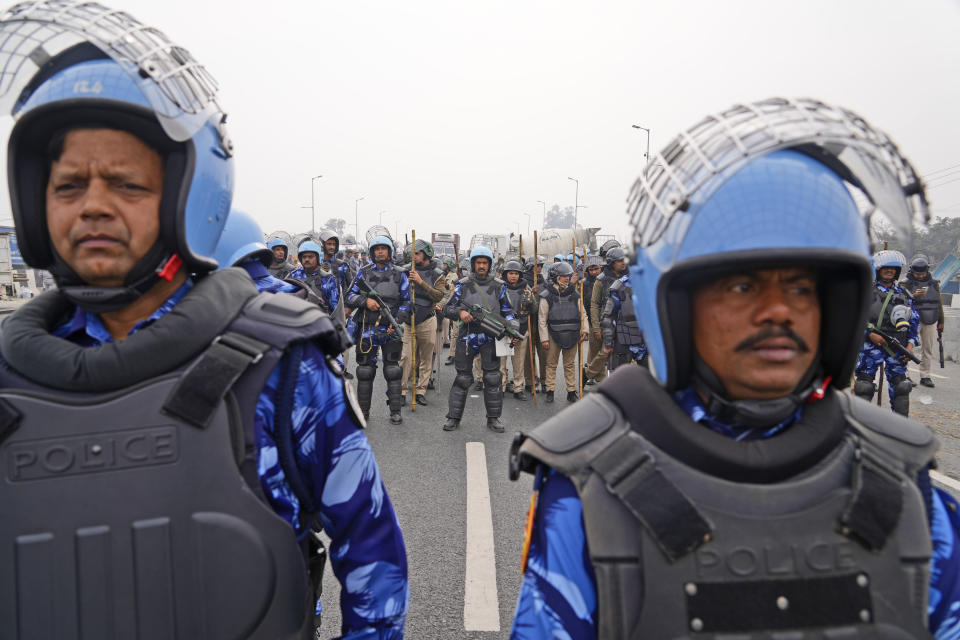 Rapid Action Force personnel guard a major highway at Singhu near New Delhi to stop thousands of protesting farmers from entering the capital, India, Tuesday, Feb.13, 2024. Farmers, who began their march from northern Haryana and Punjab states, are asking for a guaranteed minimum support price for all farm produce. (AP Photo/Manish Swarup)