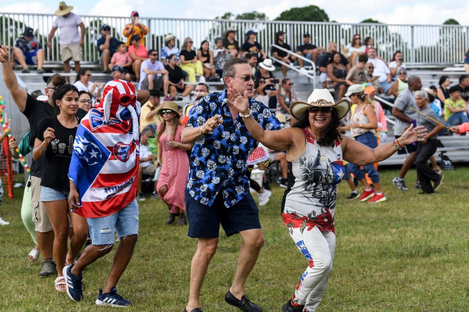 Spectators dance for the performers during the Viva Brevard Festival at Fred Poppe Regional Park in Palm Bay. Craig Bailey/FLORIDA TODAY via USA TODAY NETWORK