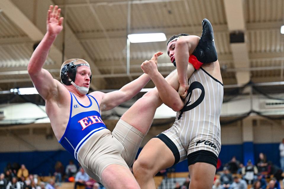 Elkhart’s Ethan Freedline, left, and Penn’s Zymarion Hollyfield wrestle in the 170 lb. championship Saturday, Jan. 14, 2023, at Elkhart High School. Hollyfield won.