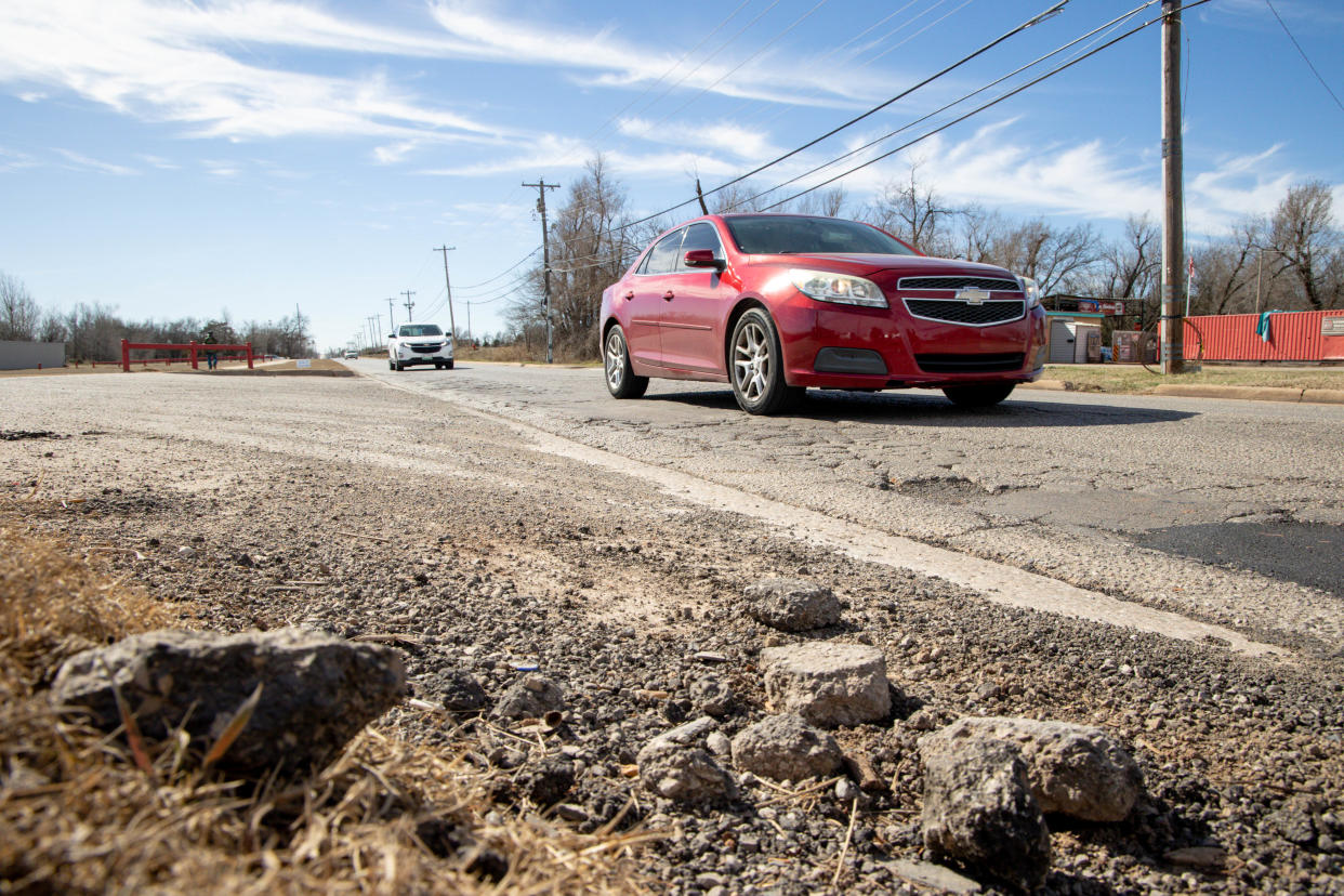 Cars drive past crumbling portions of S Bryant Avenue between SE 29 and SE 44 in Oklahoma City.