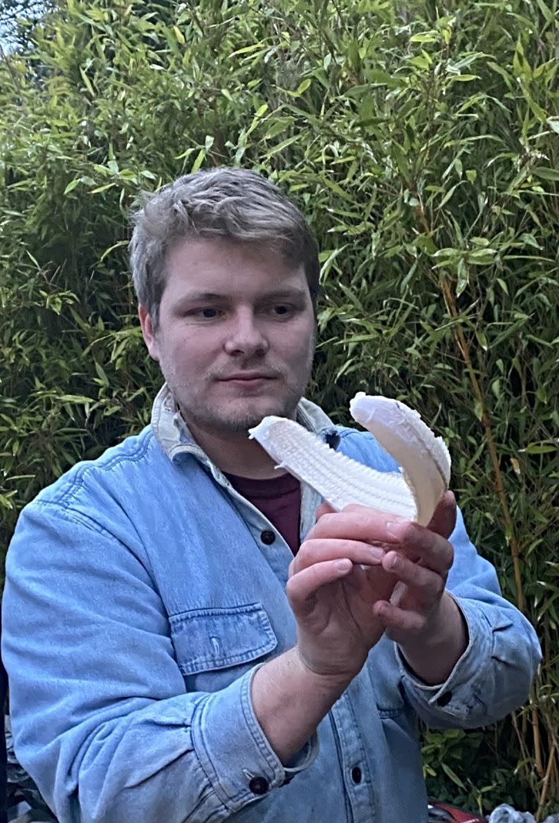 Ewan Camplisson poses with the lower portion of a Greenland shark jaw before preservation