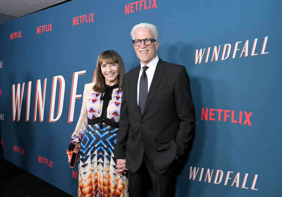 the couple smiling at a premiere