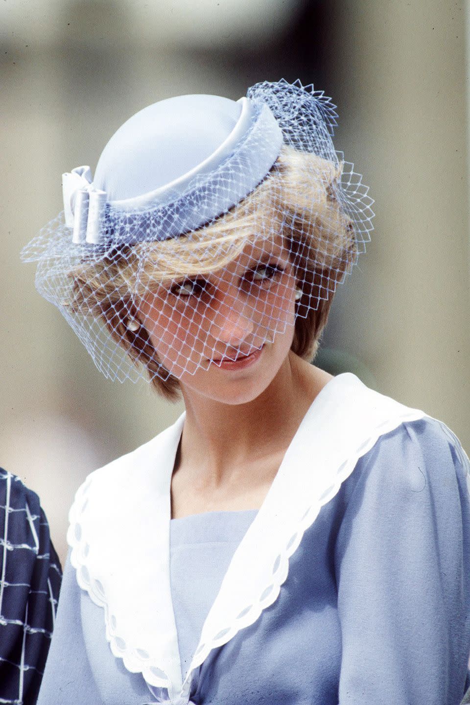 <p>In a baby blue cap with netted veil on a visit to Canada. </p>