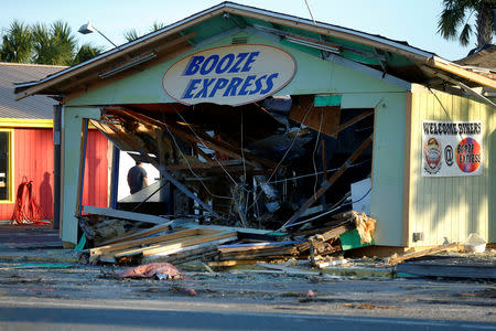 A man inspects a damaged building caused by Hurricane Michael in Panama City Beach, Florida, U.S. October 11, 2018. REUTERS/Jonathan Bachman