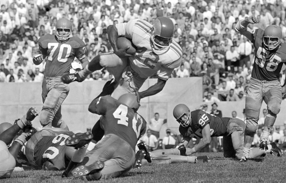 Ohio State back Paul Warfield (42) barrels along in the third quarter in Bloomington, Ind., on 5, 1963, into the waiting arms of Indiana's back Marvin Woodson (40). Warfield gained about 5 yards on the play. Ohio State won, 21-0.