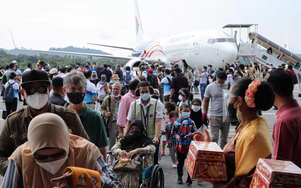 Tourists arrive at the airport - Reuters