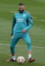 Real Madrid's Karim Benzema kicks a ball during a Media Opening day training session in Madrid, Spain, Tuesday, May 24, 2022. Real Madrid will play Liverpool in Saturday's Champions League soccer final in Paris. (AP Photo/Manu Fernandez)