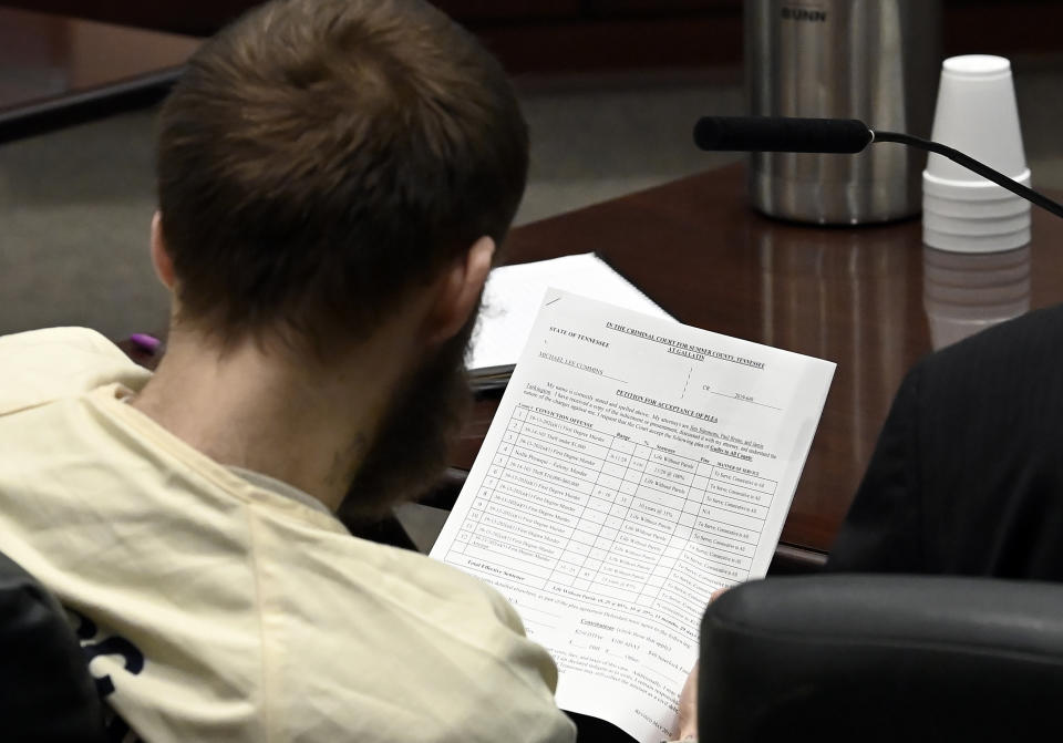 Michael Cummins looks at his petition for acceptance of plea during his court hearing at the Sumner County Justice Center on Wednesday, Aug. 16, 2023, in Gallatin Tenn. Cummins who killed eight people in rural Westmoreland over several days in April 2019, has pleaded guilty to eight counts of first-degree murder in exchange for a sentence of life without parole. (Mark Zaleski/The Tennessean via AP, Pool)