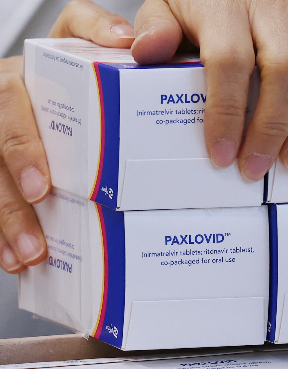 A pharmacist checks boxes containing Paxlovid, a Covid-19 treatment pill developed by U.S. pharmaceutical giant Pfizer Inc. Source: AAP