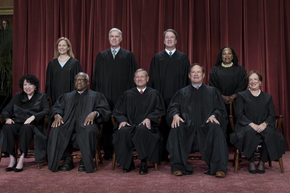 FILE - Members of the Supreme Court sit for a group portrait at the Supreme Court building in Washington, Oct. 7, 2022. Bottom row, from left, Justice Sonia Sotomayor, Justice Clarence Thomas, Chief Justice of the United States John Roberts, Justice Samuel Alito, and Justice Elena Kagan. Top row, from left, Justice Amy Coney Barrett, Justice Neil Gorsuch, Justice Brett Kavanaugh, and Justice Ketanji Brown Jackson. As the U.S. Supreme Court is expected to rule on a major case involving former President Donald Trump, 7 in 10 Americans think its justices are more likely to shape the law to fit their own ideology, rather than serving as neutral arbiters of government authority, according to a new poll. (AP Photo/J. Scott Applewhite)