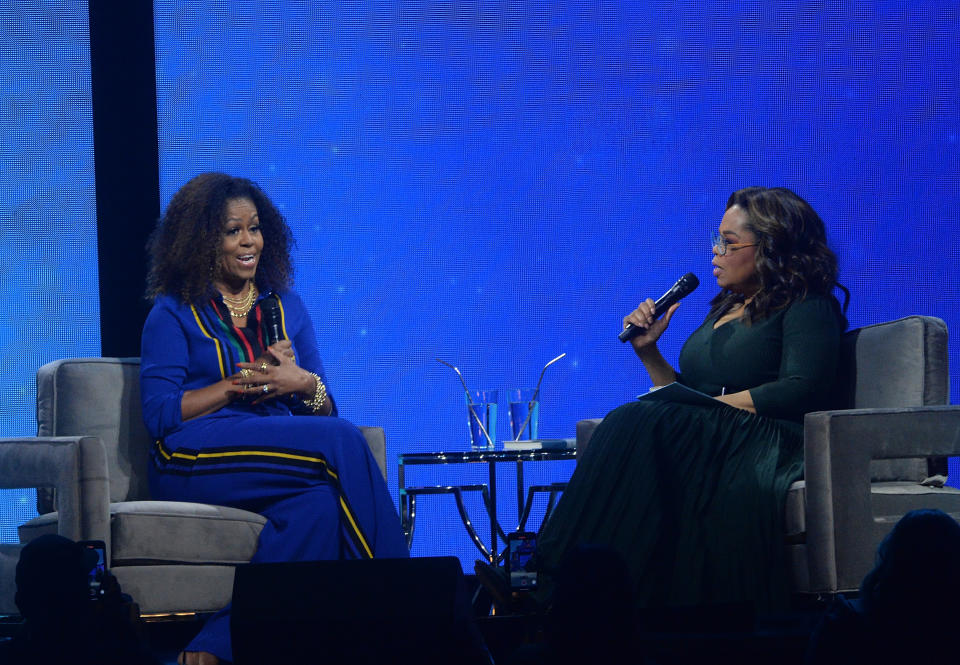 Michelle Obama, left, and Oprah Winfrey speak onstage at "Oprah's 2020 Vision: Your Life in Focus" tour at the Barclays Center on Saturday, Feb. 8, 2020, in New York. (Photo by Brad Barket/Invision/AP)