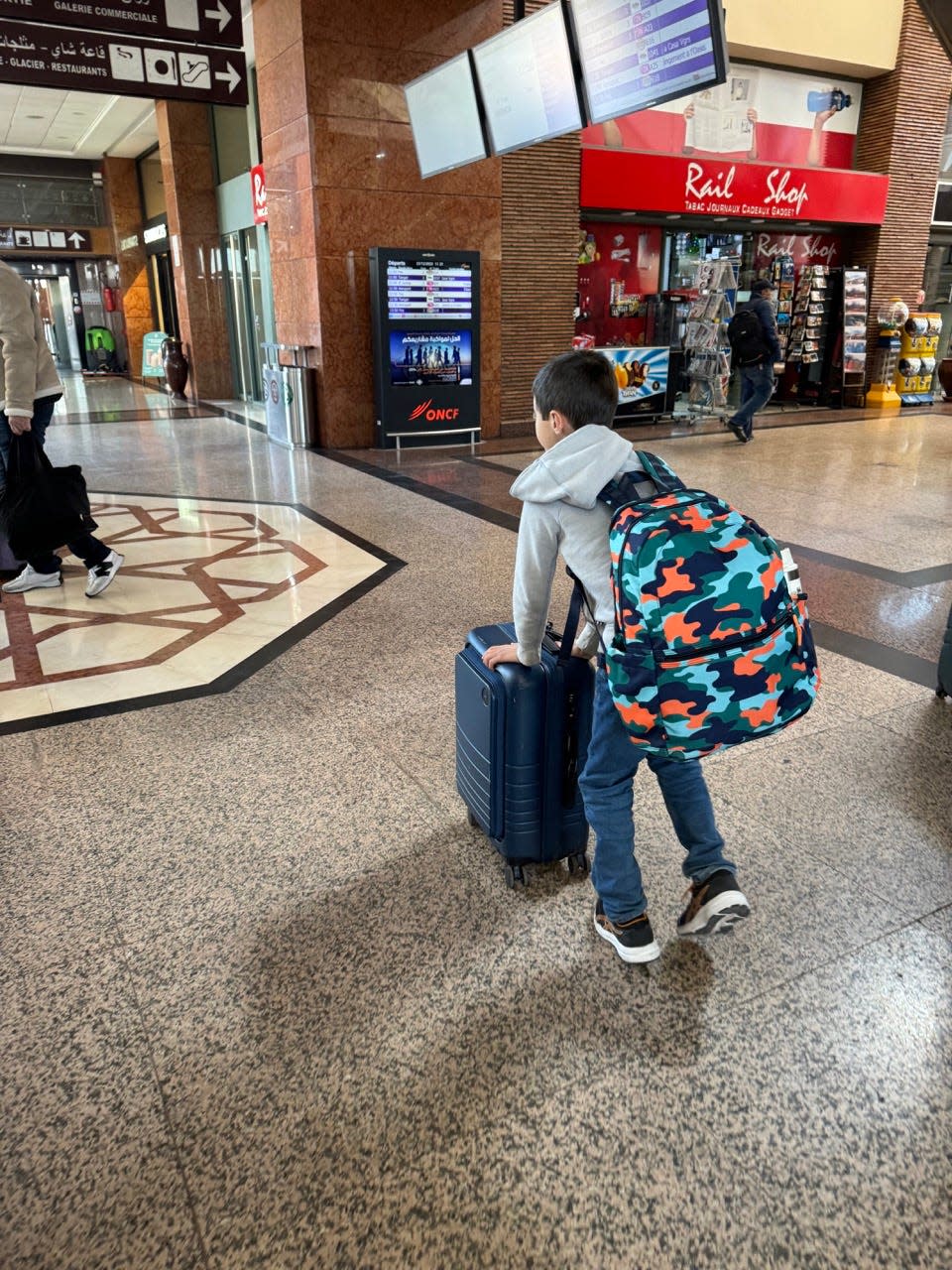 Kid with backpack in train station