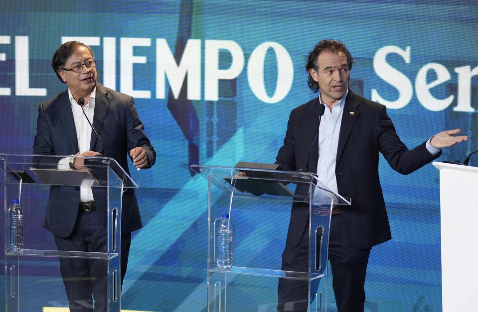 Federico Gutierrez, presidential candidate representing the Team for Colombia coalition, right, and presidential candidate Gustavo Petro with the Historical Pact coalition, left, take part in a presidential debate at the El Tiempo newspaper building in Bogota, Colombia, Monday, May 23, 2022, ahead of the first round May 29th elections. (AP Photo/Fernando Vergara)