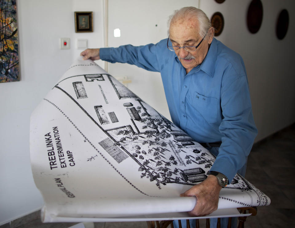 In this Sunday, Oct. 31, 2010 photo holocaust survivor Samuel Willenberg, who died 2016, displays a map of the Treblinka extermination camp during an interview with the Associated Press at his house in Tel Aviv, Israel. Ada Krystyna Willenberg, the widow of one revolt fighter Samuel Willenberg, appealed Thursday for a proper museum to be built at the site of the former camp. The current memorial consists of boulders bearing the names of locations that the inmates came from. (AP Photo/Oded Balilty, file)