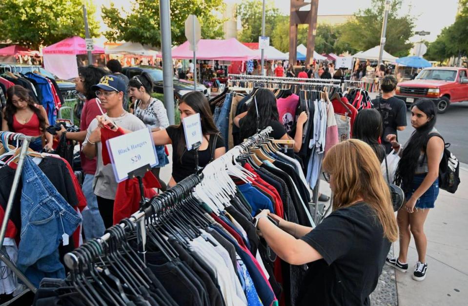 Clothing is sold by a vendor along Fulton Street at Mariposa Mall during ArtHop which has developed into much more than just art galleries. Photographed Thursday, Aug. 3, 2023.