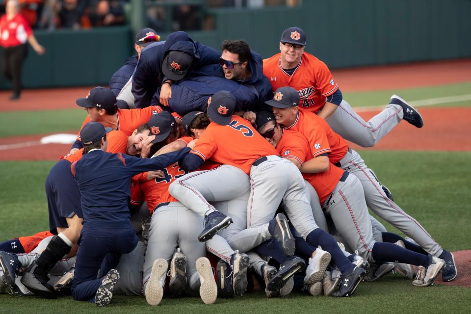 Auburn players celebrate their win over Oregon State in an NCAA college baseball tournament super regional game on Monday, June 13, 2022, in Corvallis, Ore. (AP Photo/Amanda Loman)